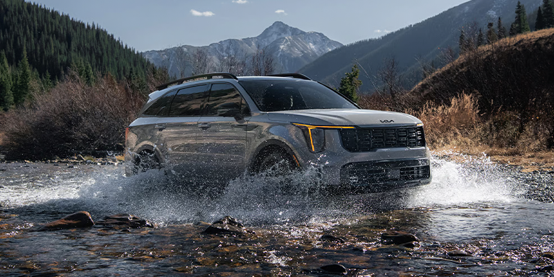 A Kia Sorento driving in shallow water