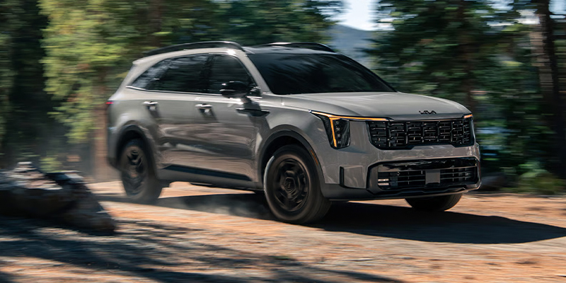 A silver Kia Sorento driving off-road.